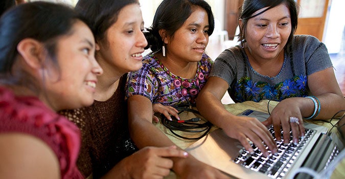 young women in Guatemala use a computer. Photo: UN Trust Fund/Phil Borges