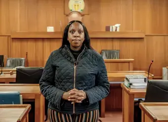 Kgomotso Modise stands in a courtroom