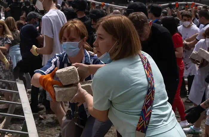 On 8 July 2024 in Kyiv, fire and rescue service workers, hospital staff and volunteers clear rubble and search for people trapped under debris after an attack that hit Okhmatdyt hospital, Ukraine's largest children's medical centre. Photo: UNICEF/UNI608590/Filippov